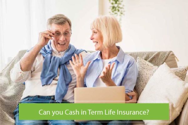 Senior couple sitting on couch looking at laptop with a surprised expression